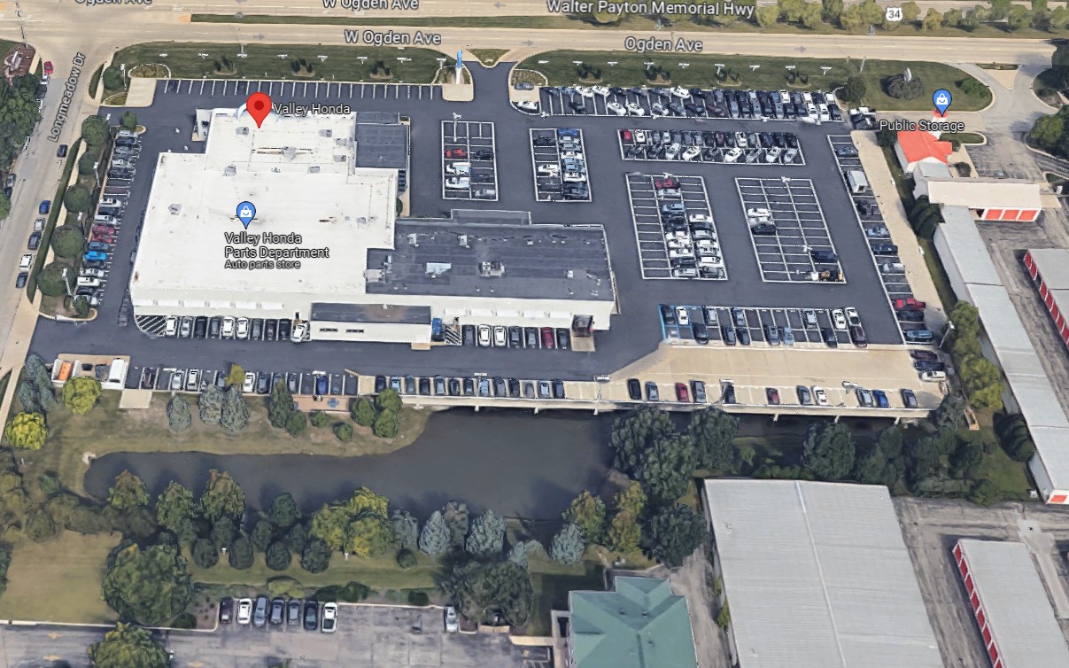 aerial Google image of Valley Honda parking lot and detention pond underneath parking deck