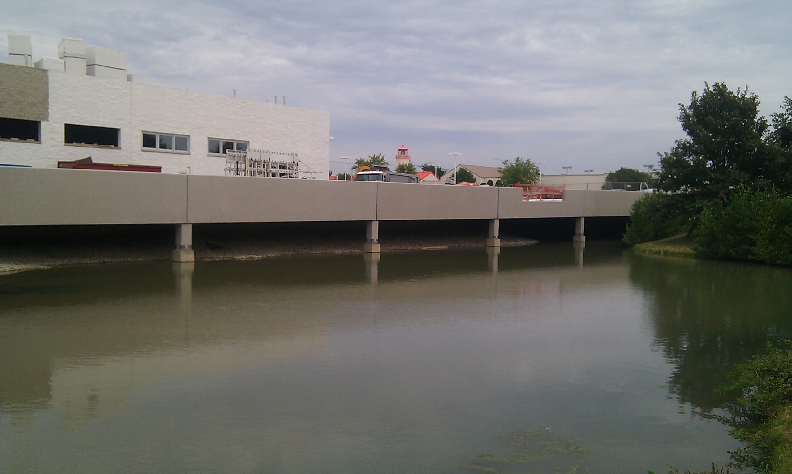 close view of detention pond that flows beneath the parking deck of Valley Honda