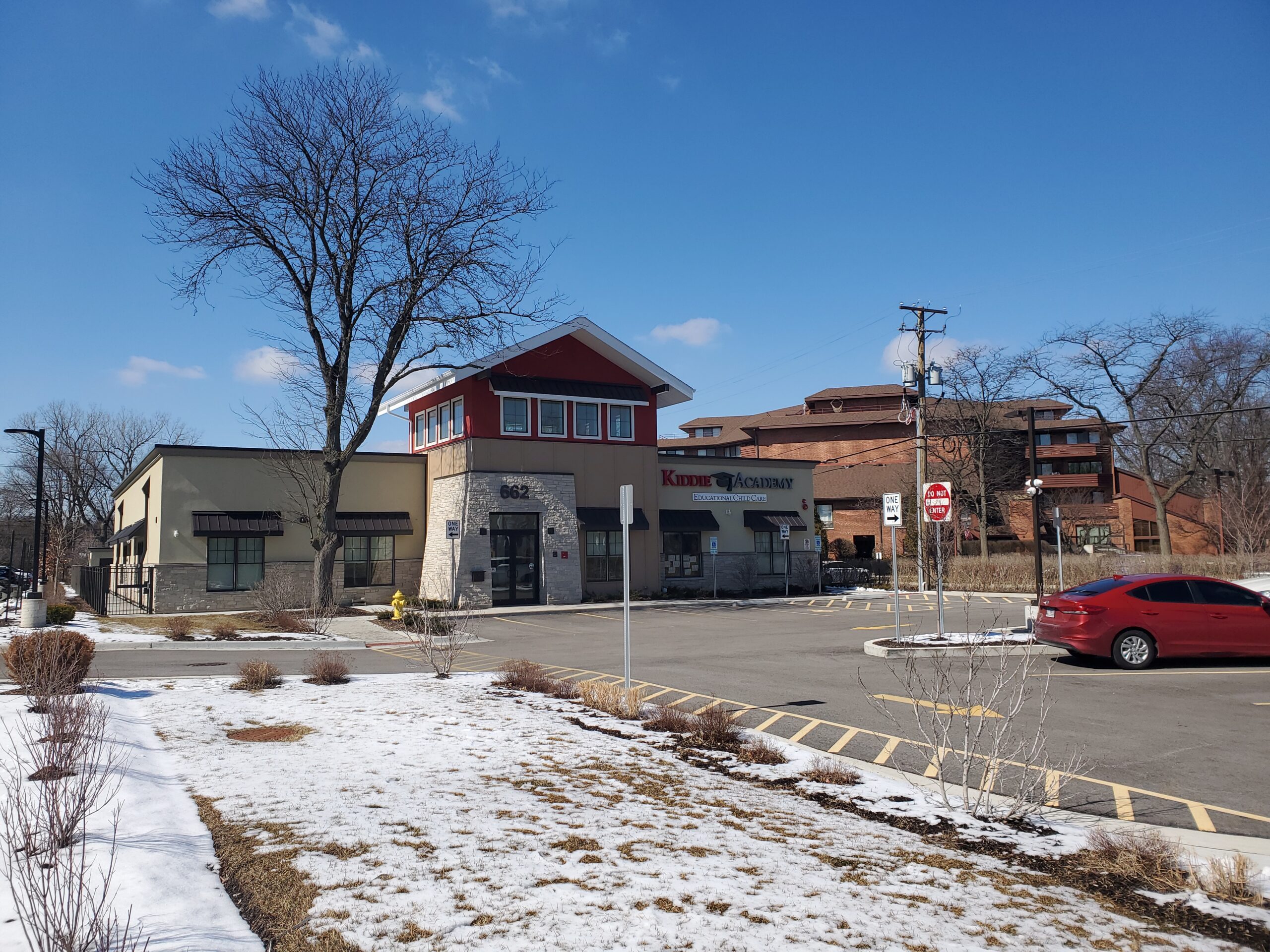 Kiddie Academy parking lot and driveway looking towards the educational child care building front door