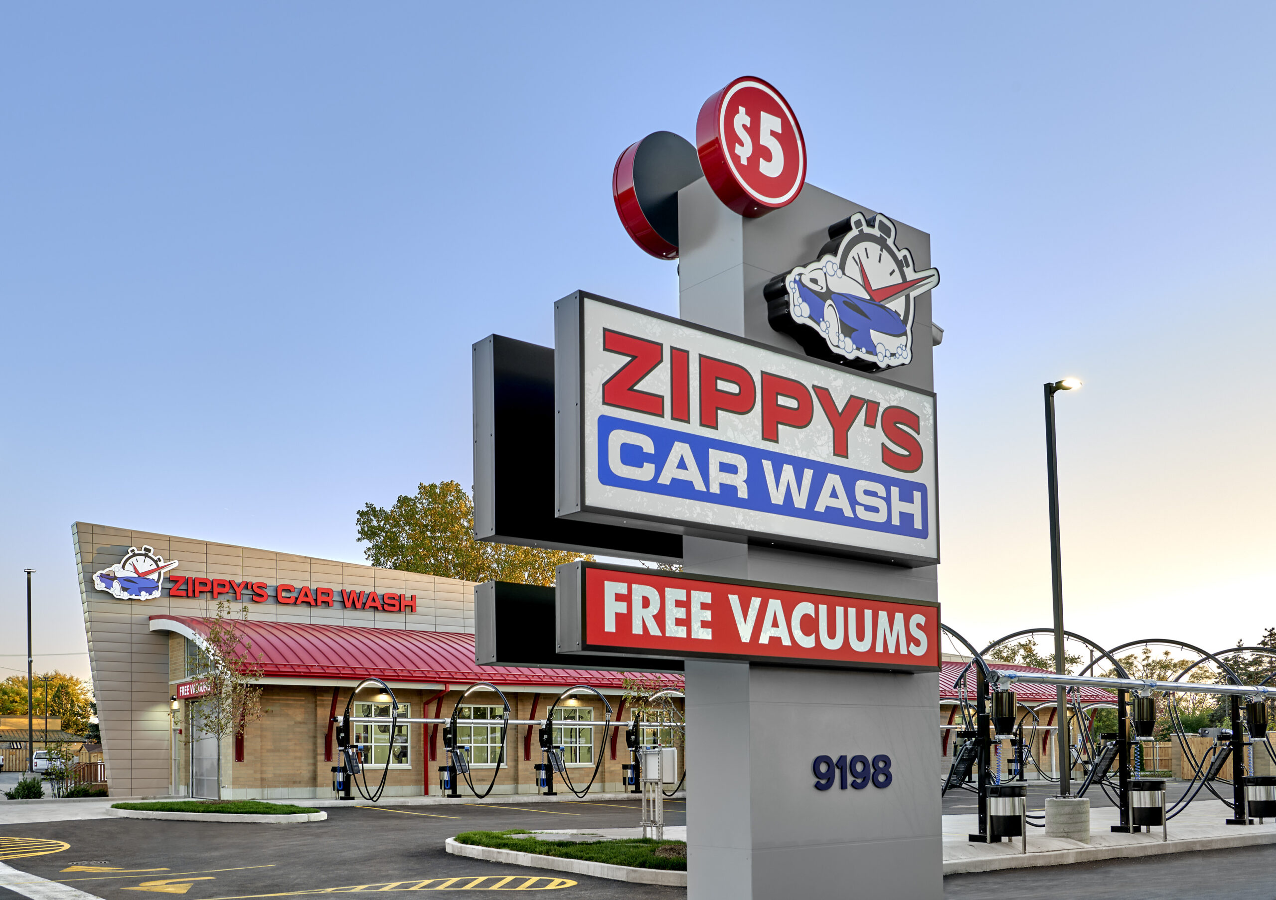 exterior signage of Zippy's car wash with parking lot in background