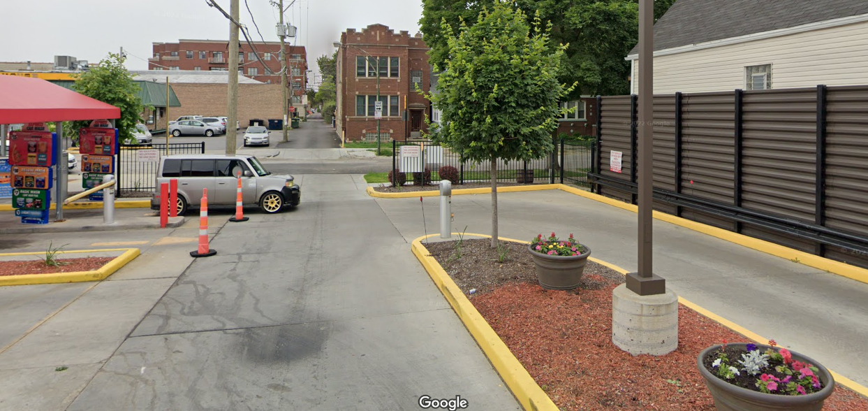 Google image view of a car driving into the driveway of the Irving Express car wash