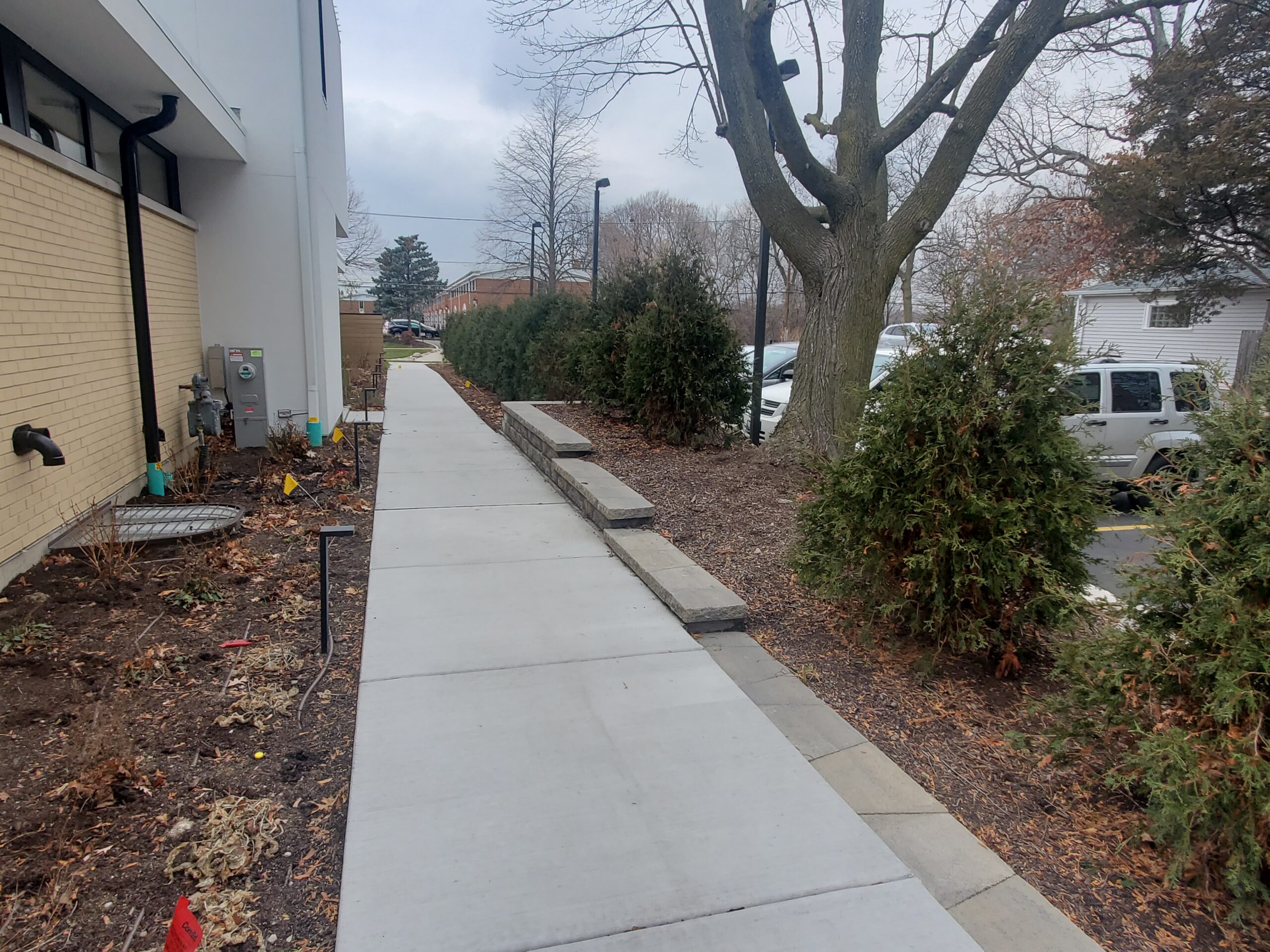 side view of the St Johns Highland Park apartments with a concrete walkway leading to the street sidewalk